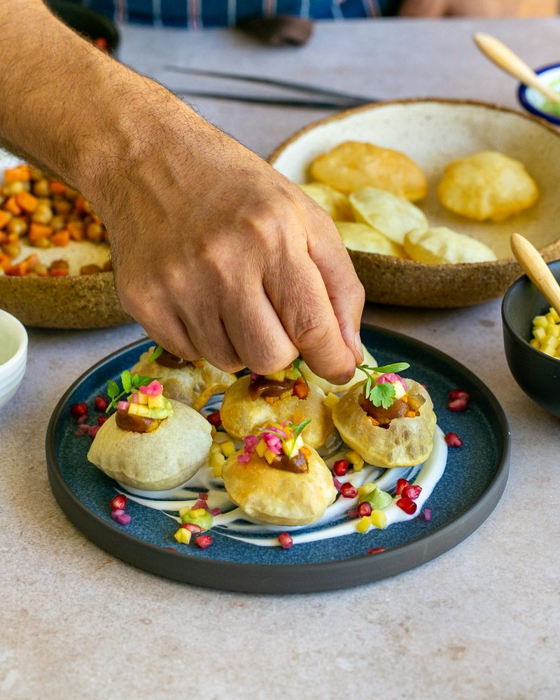 Assembling the puri bites with prepared filling