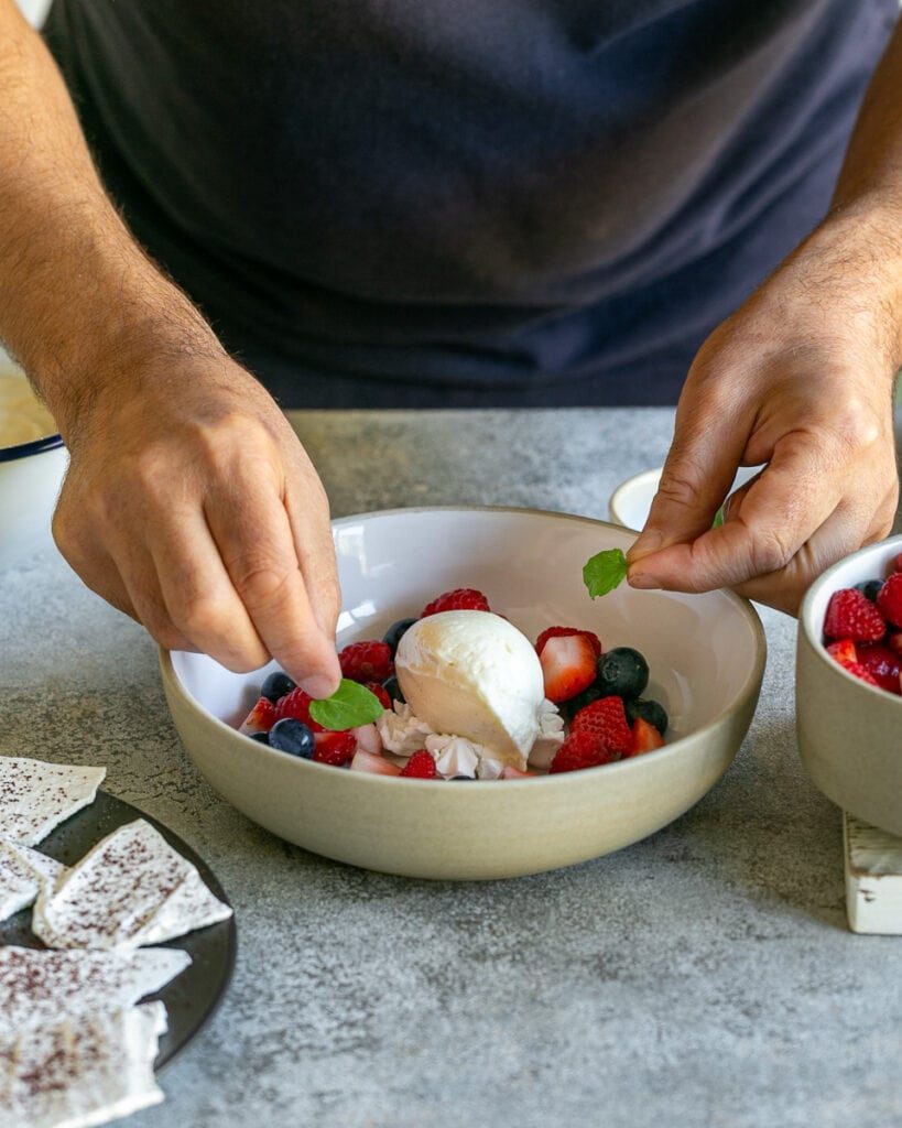 Decorating dessert with fresh mint leaves