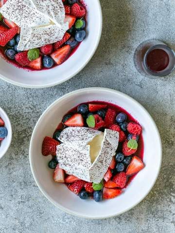 White chocolate mousse with mixed berries and meringue served in a bowl