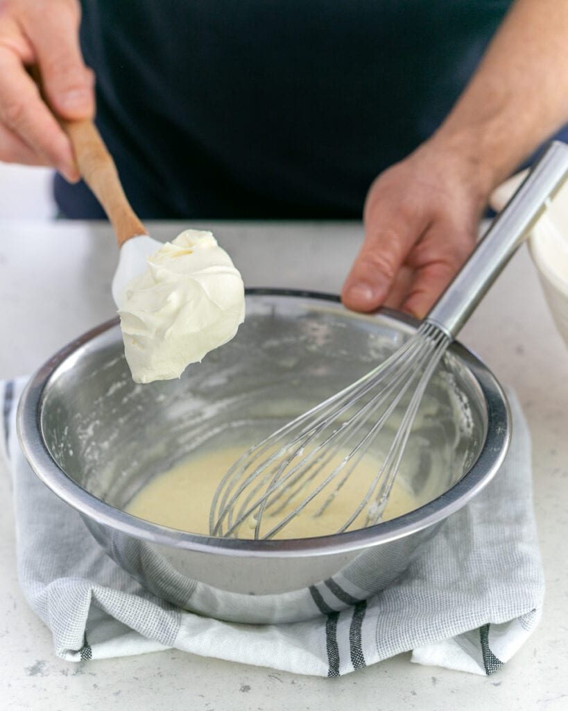 Adding whipped cream to melted chocolate and egg white mix