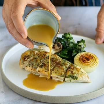 Chicken gravy served with roasted chicken breasts and kale edited