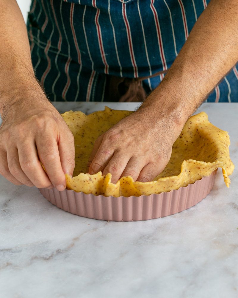 Rolled out dough in tart baking pan