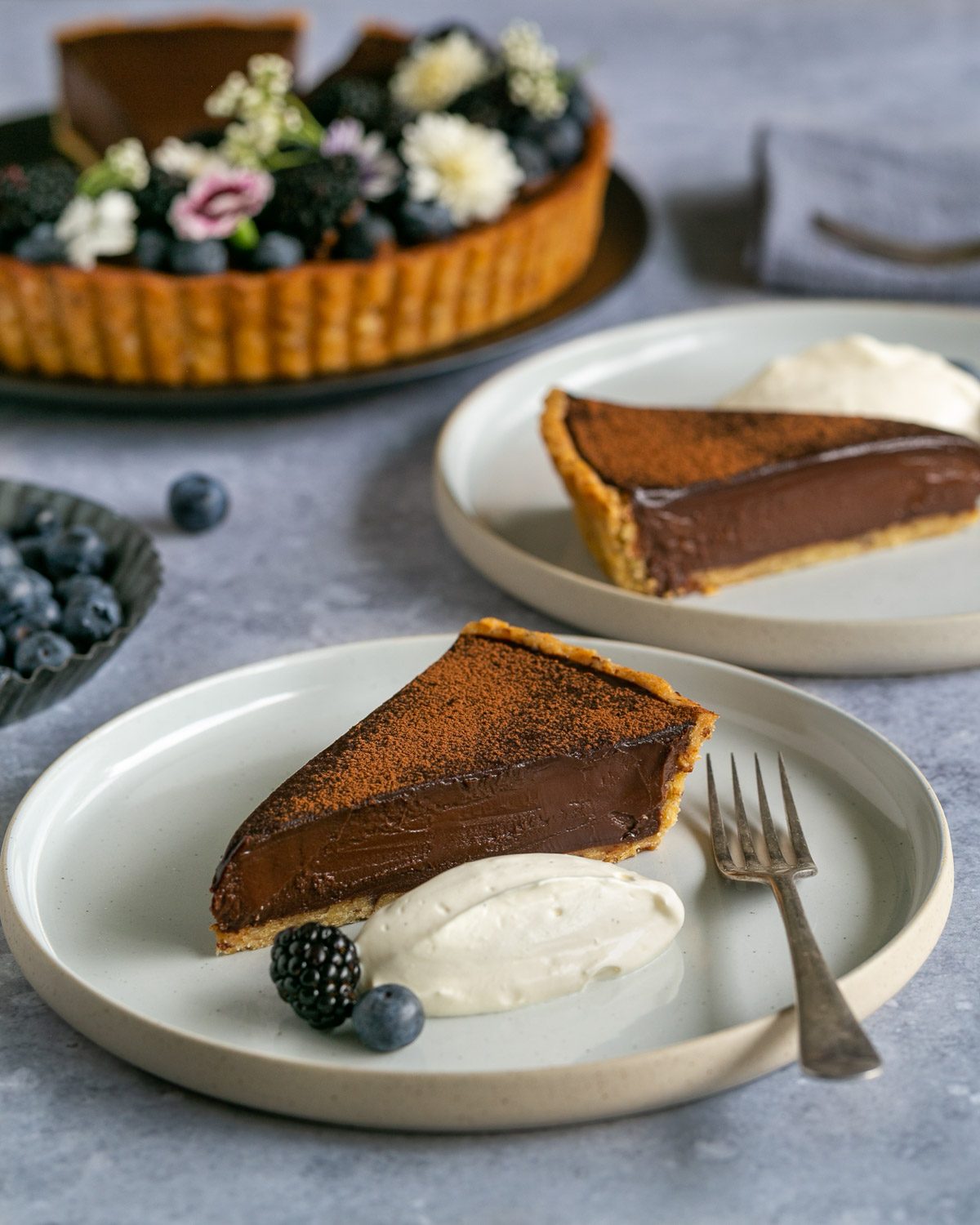 Slice of chocolate tart served with vanilla cream