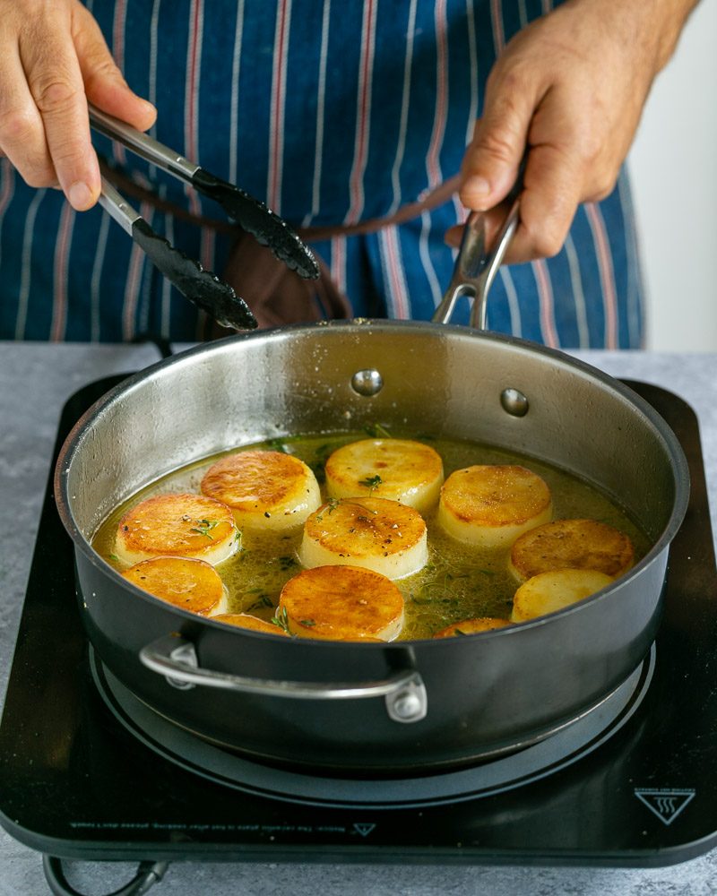 Potatoes in the chicken stock cooking