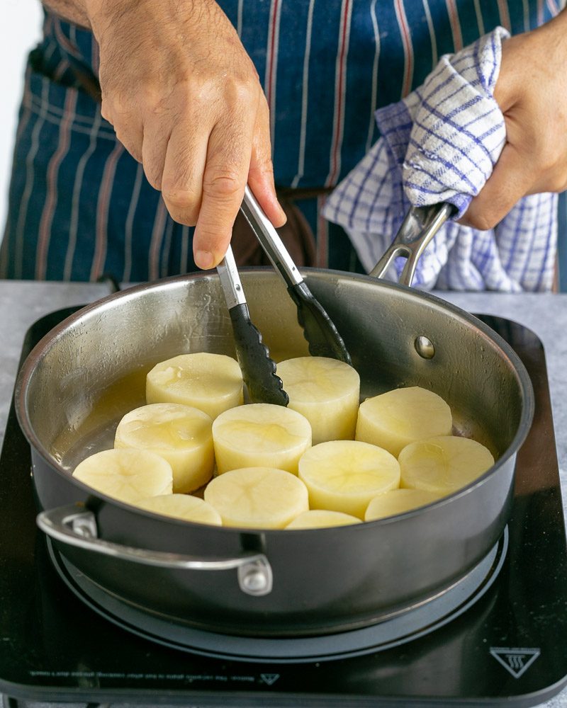 using tongs to sear VEGETABLES in a hot pan