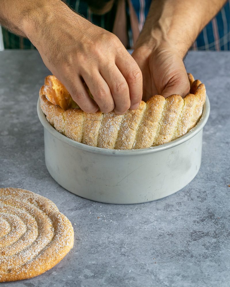 Placing ladyfinger band within the cake mould