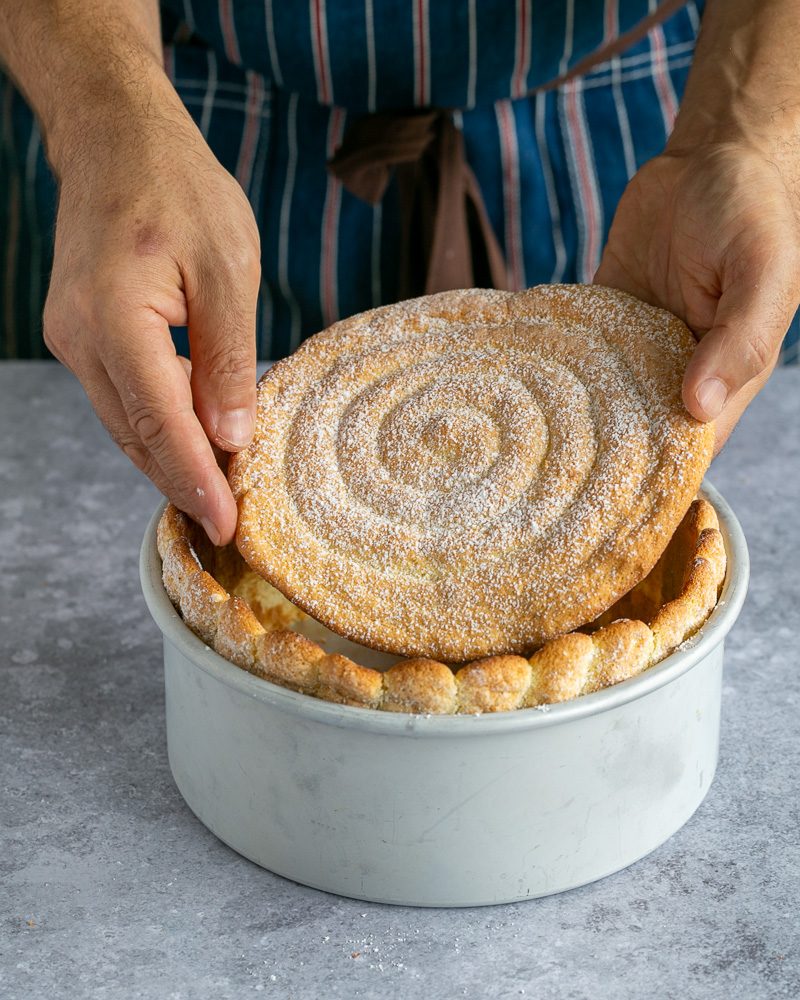 Placing the round cake sponge within the cake mould