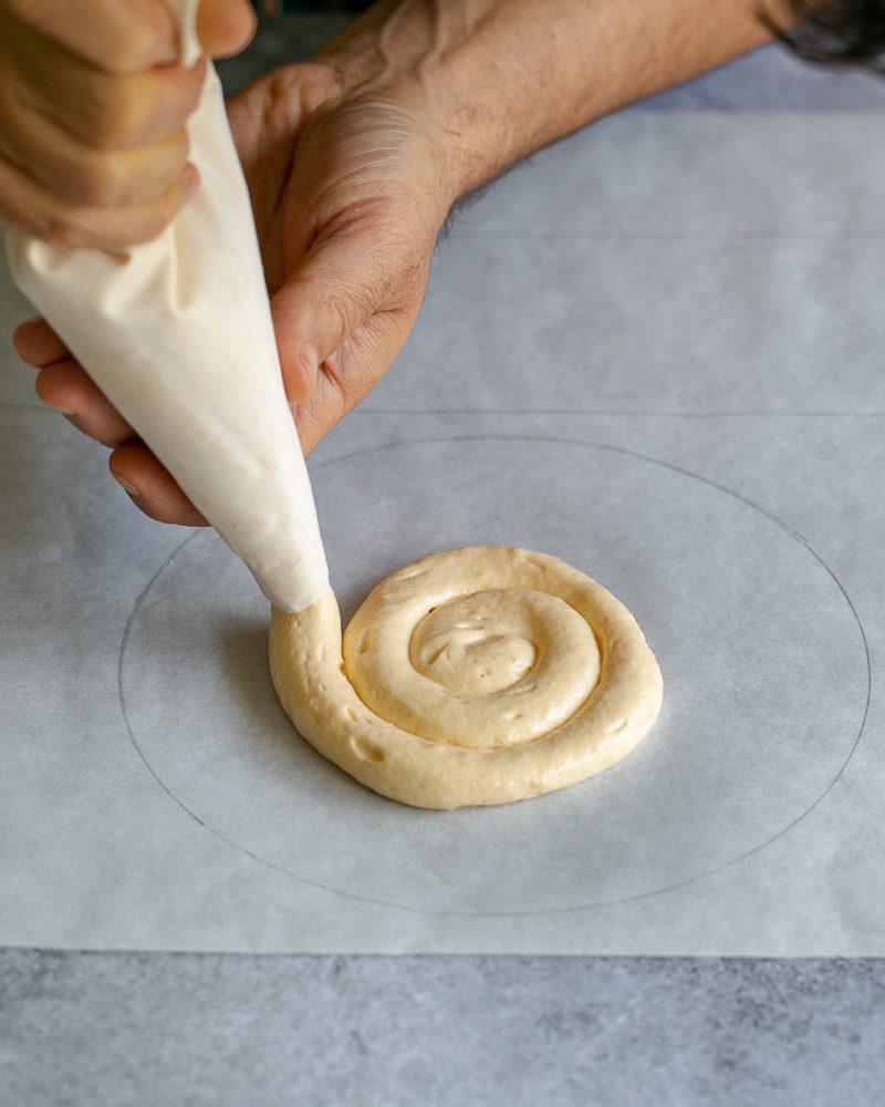 Piping the sponge cake on prepared sketch