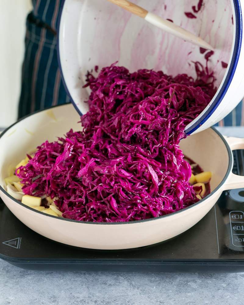 Adding marinated cabbage to the pot