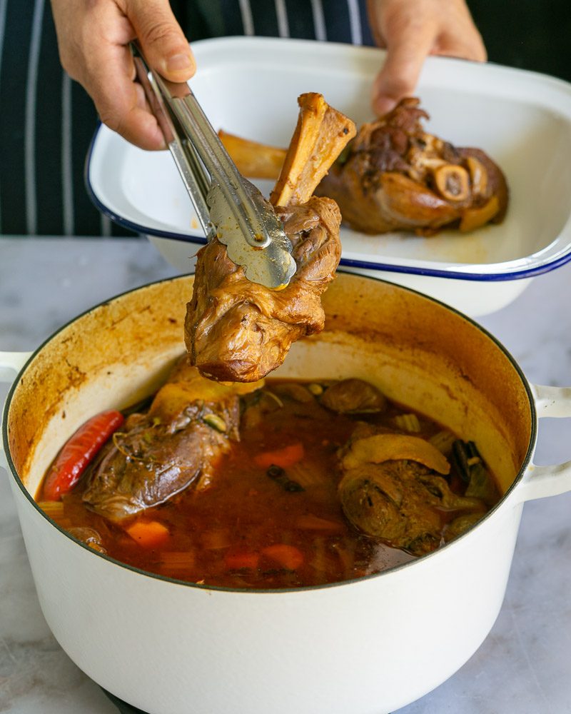 Remove cooked lamb shanks from braiding liquid