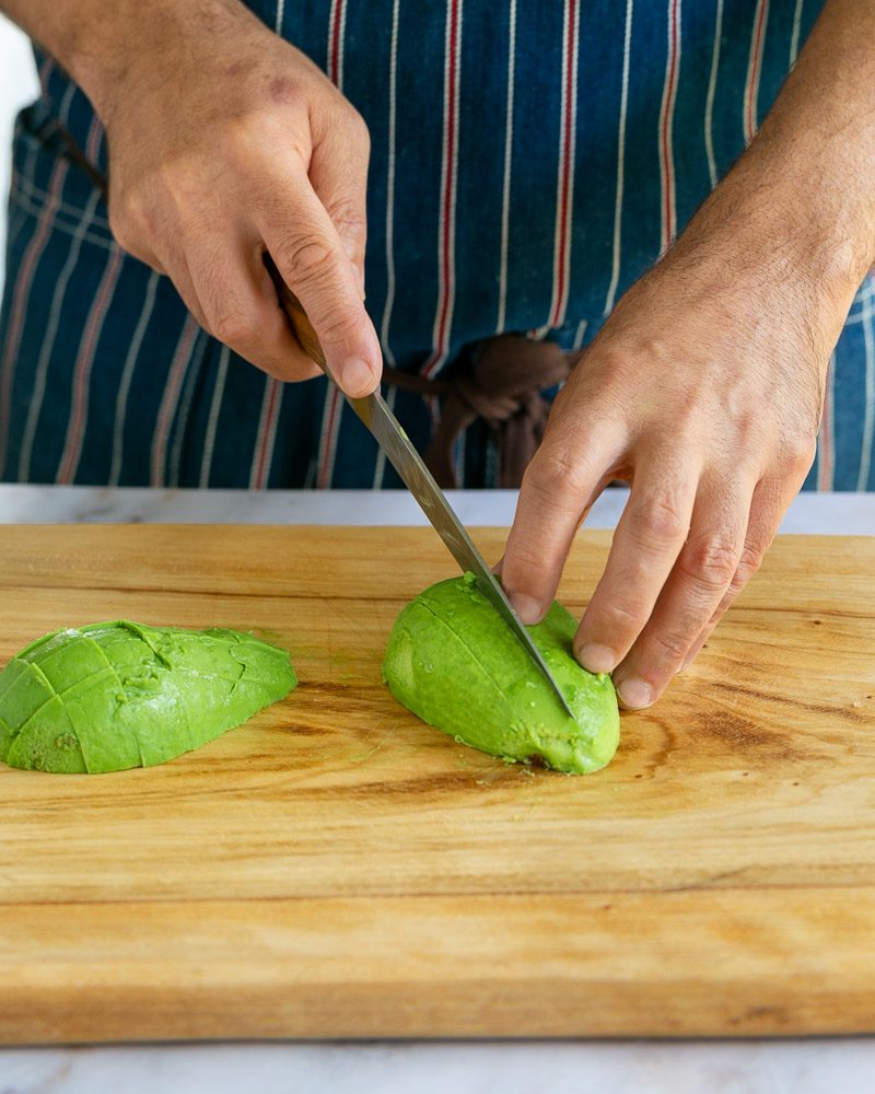 Cutting avocado to add to salad cocktail mix