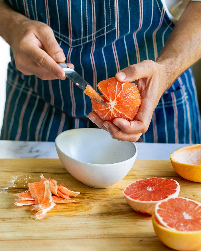 cutting grapefruit segments with a knife