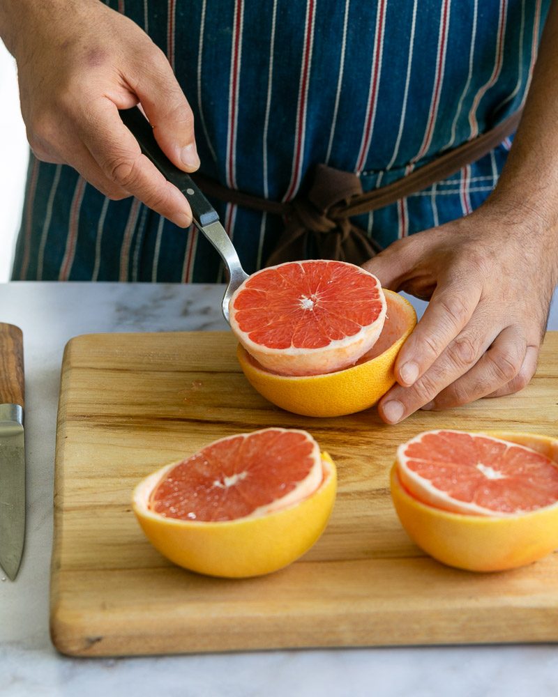 Scooping out the grapefruit form the grapefruit half