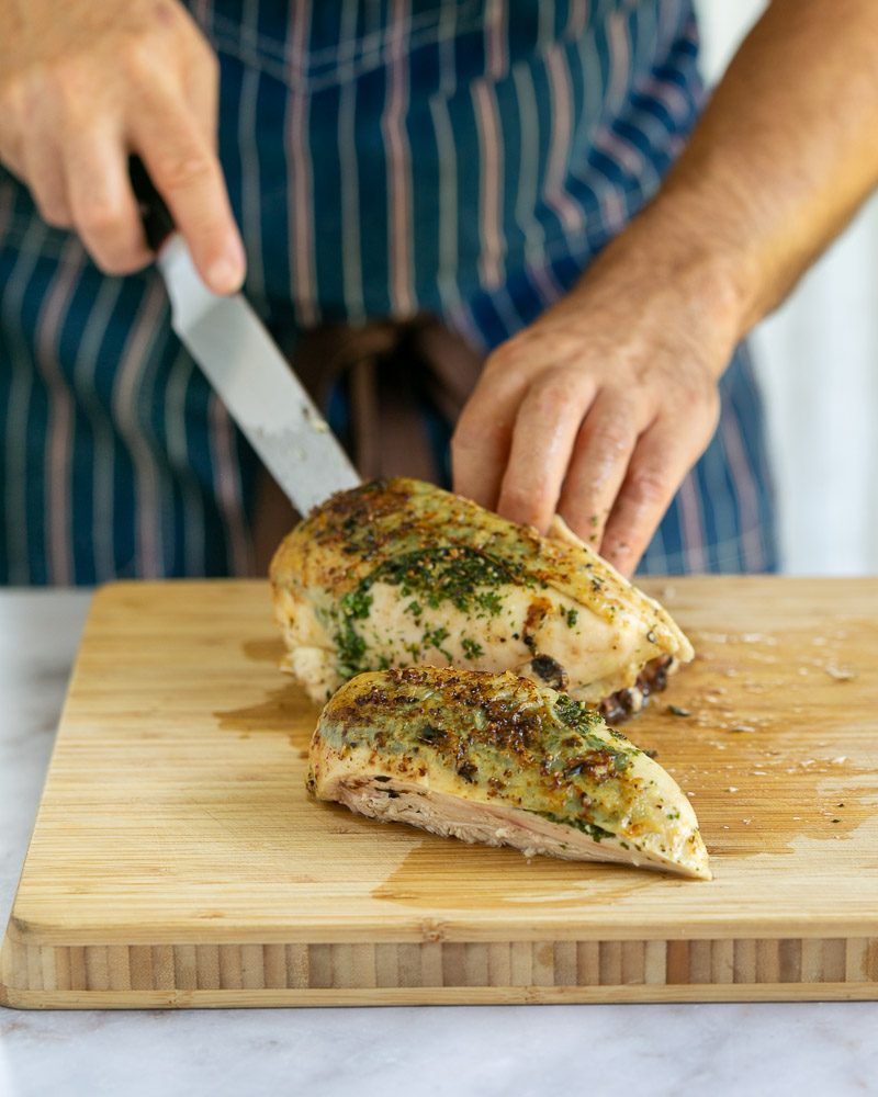 Removing the chicken breasts off the bone