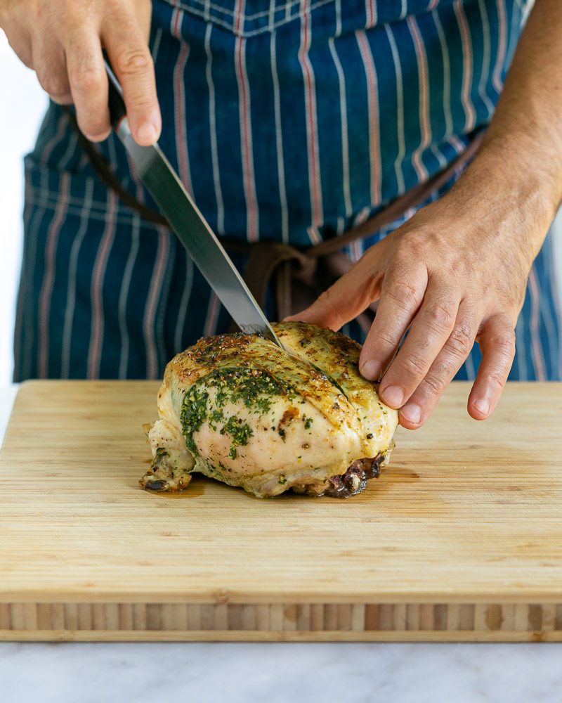 Separating the chicken breasts from the bone