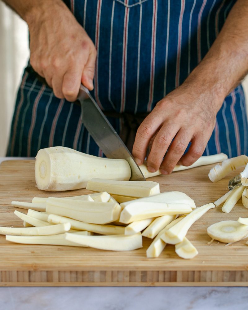 Cutting parsnip lengthwise to roast