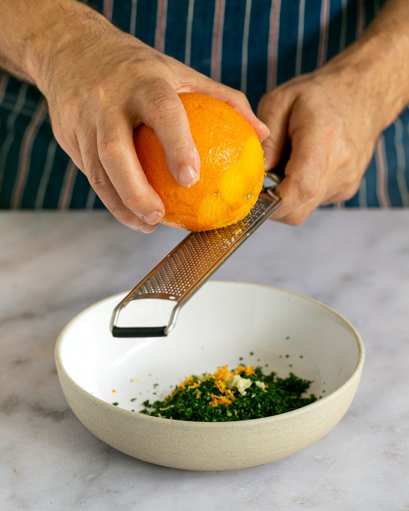 Grating orange zest for the gremolata