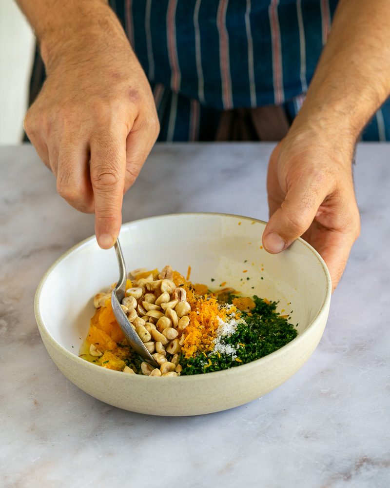 mixing the gremolata with all the ingredients in a bowl