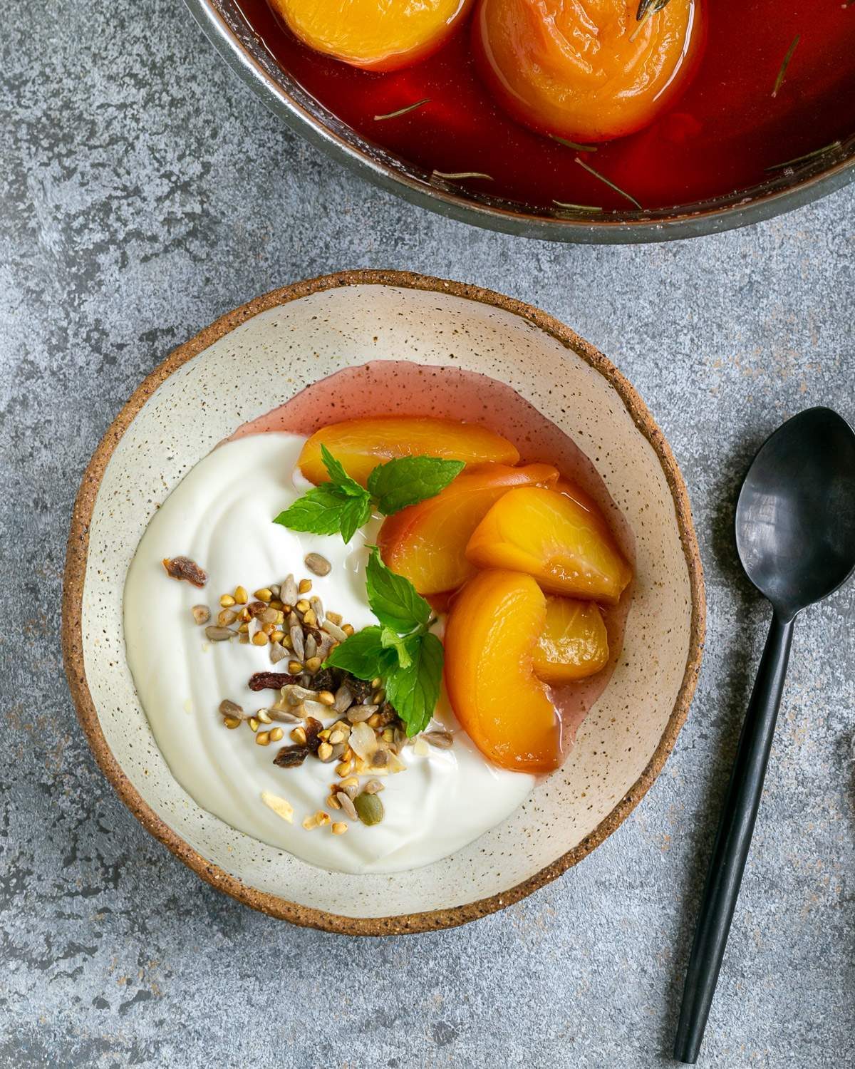 Poached peached served with yoghurt and nuts