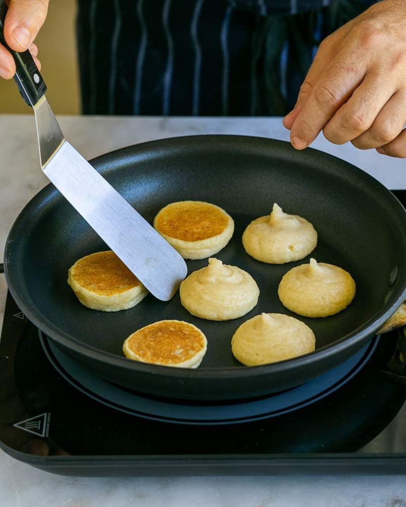 Flipping blinis in pan