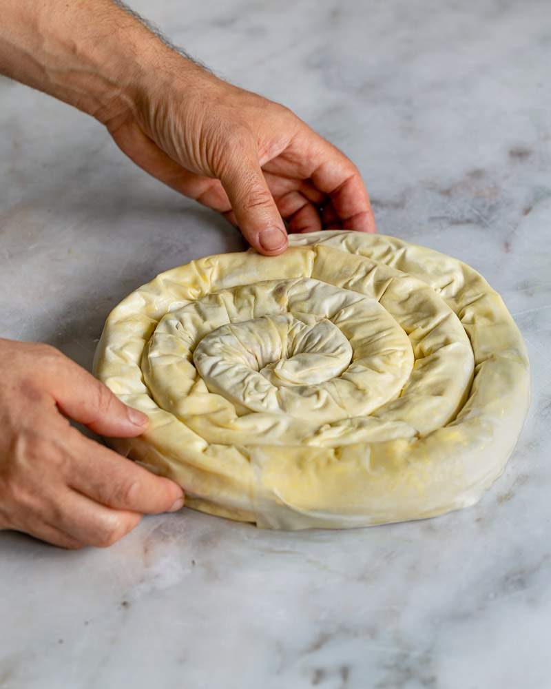 Rolling the stuffed filo into a spiral