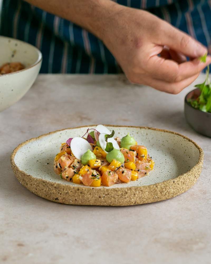 garnishing the plated salmon tartare