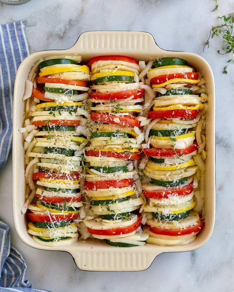 Sliced vegetables arranged in baking dish