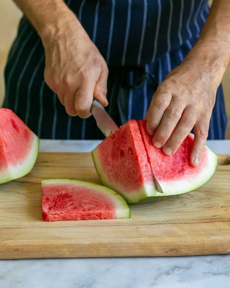 Cutting watermelon to make salad 
