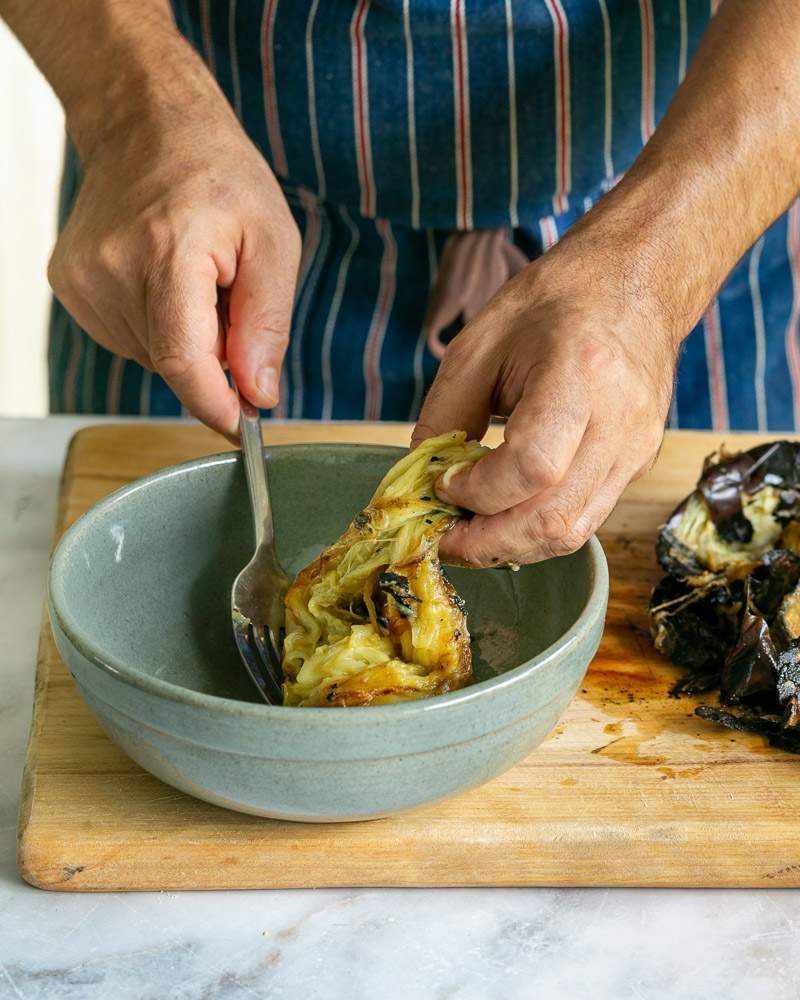 Removing the skin from the roasted eggplant