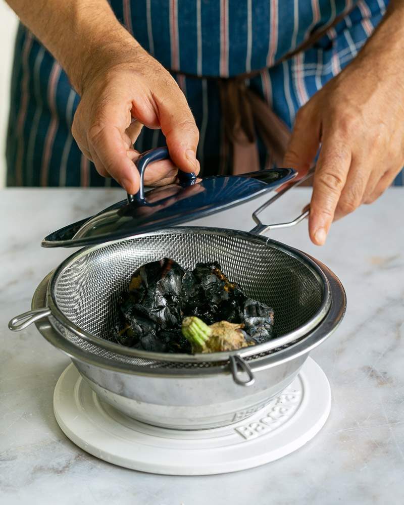 straining the roasted eggplant