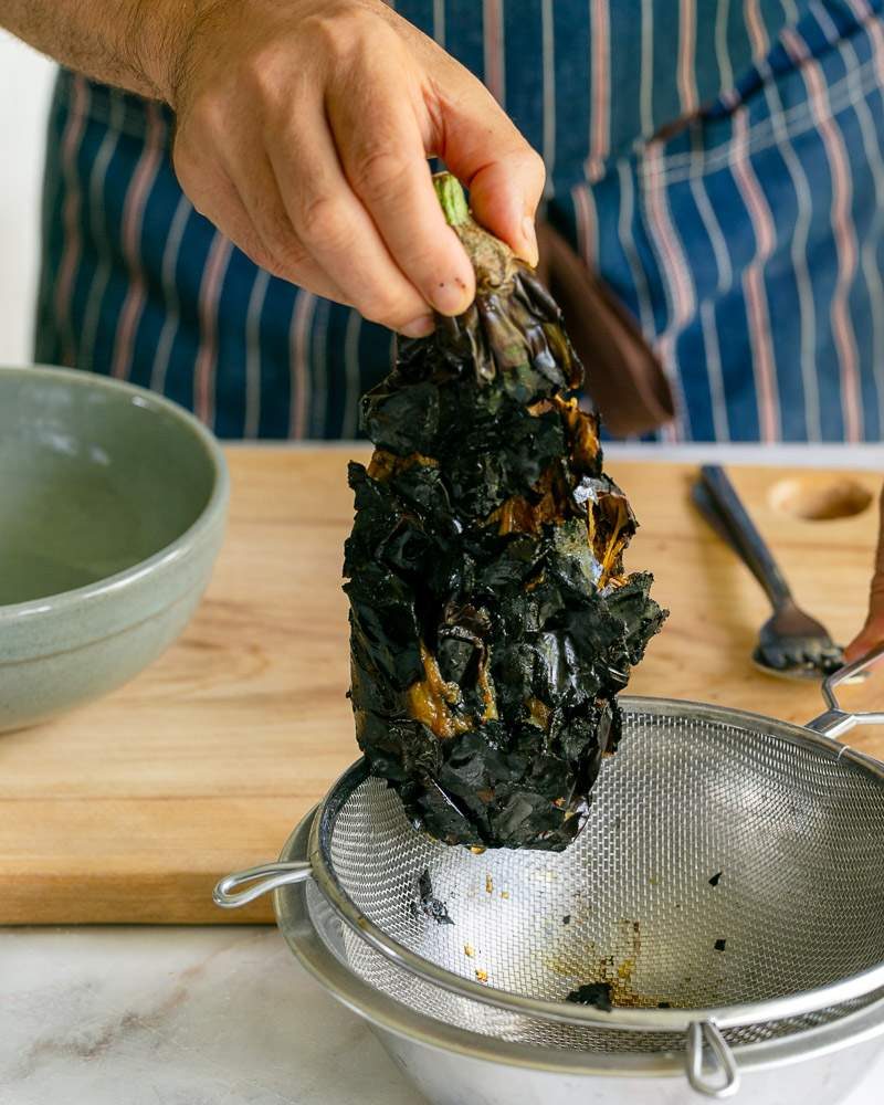 straining the roasted eggplant