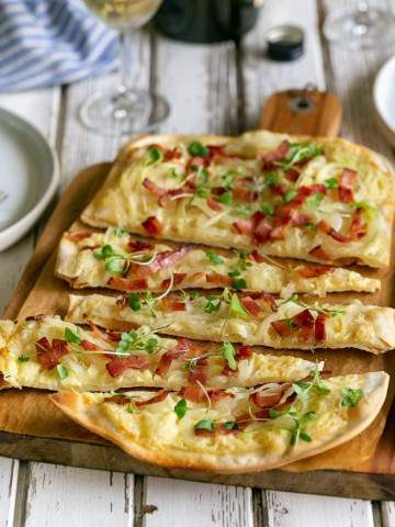Flammkuchen slices on a wooden board