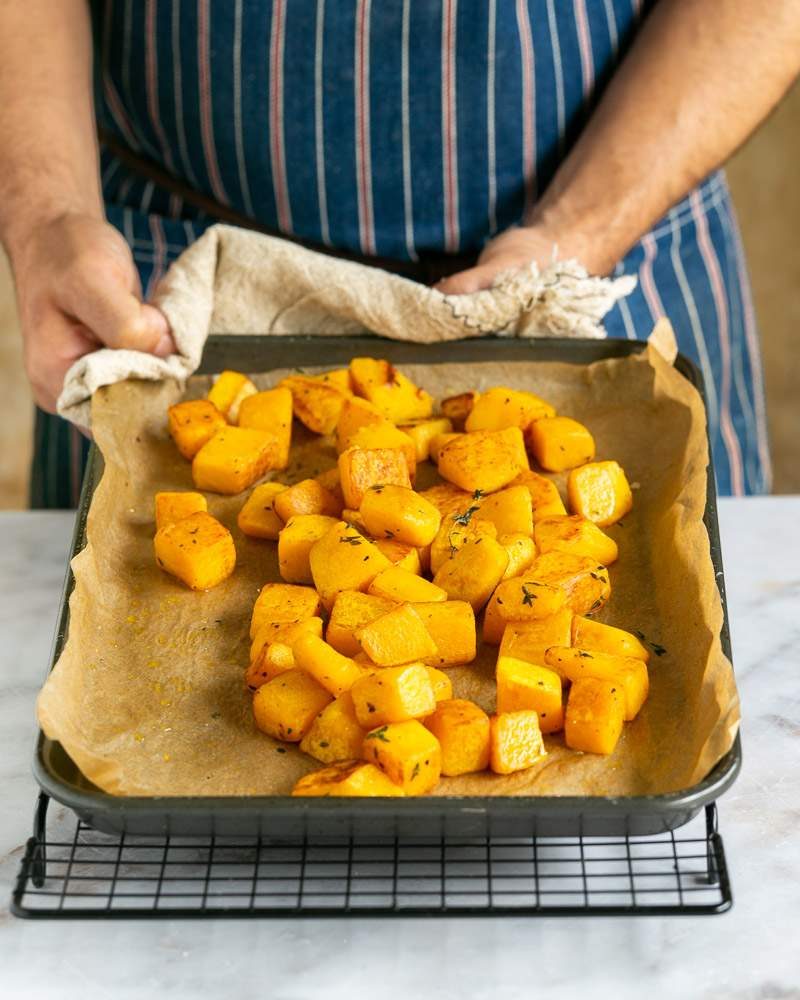 Roasted pumpkin cubes in oven tray