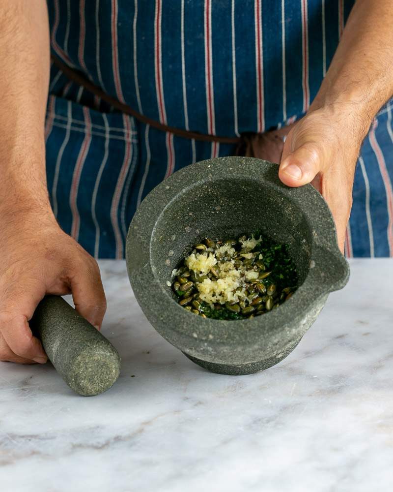 Pesto ingredients in the mortar pestle