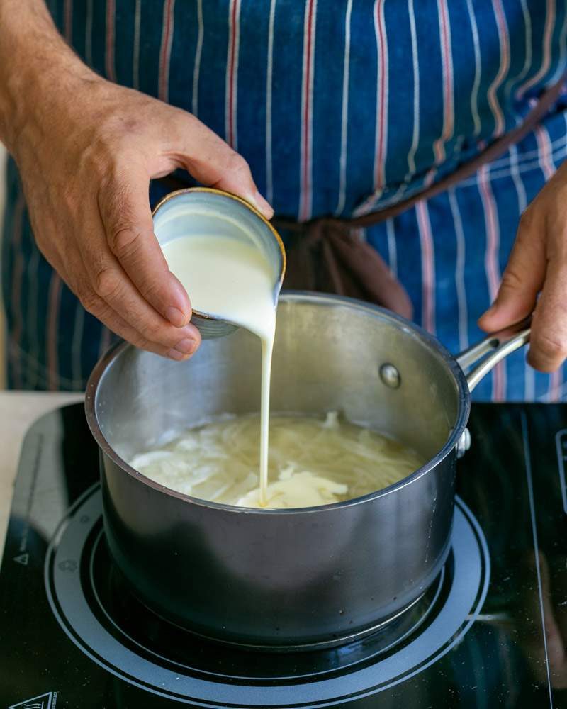 Adding cream to onions