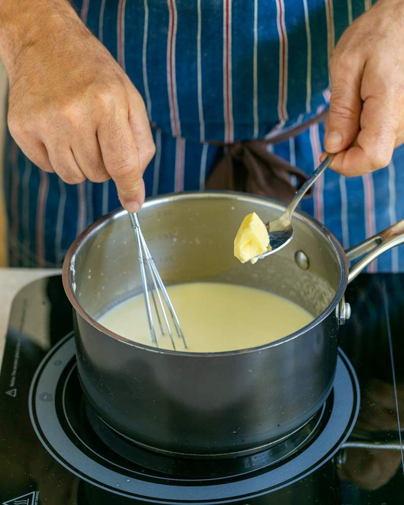 adding butter to blended sauce