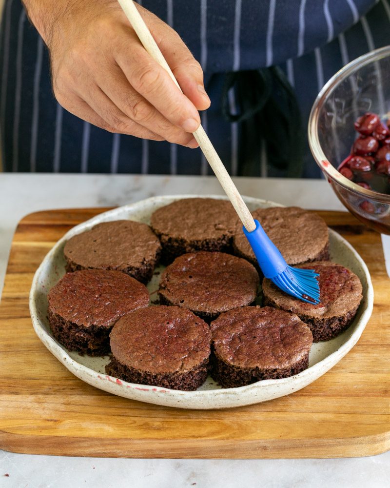 Soaking cut sponge cake with cherry juice