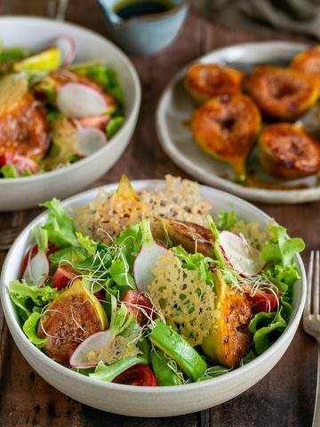 Fig salad with parmesan crisps arranged in a bowl
