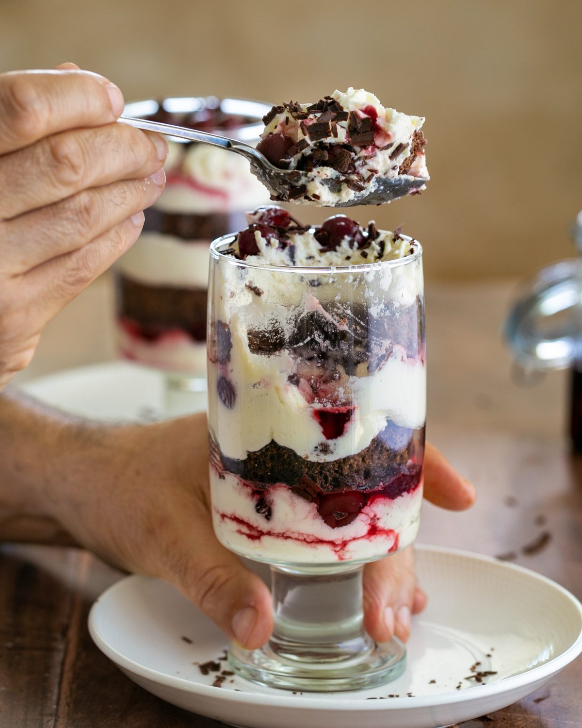 Spoon full of black forest cake in glass