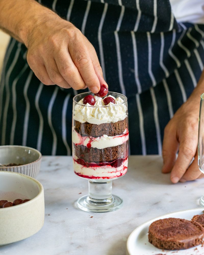 Top the assembled black forest with cherries