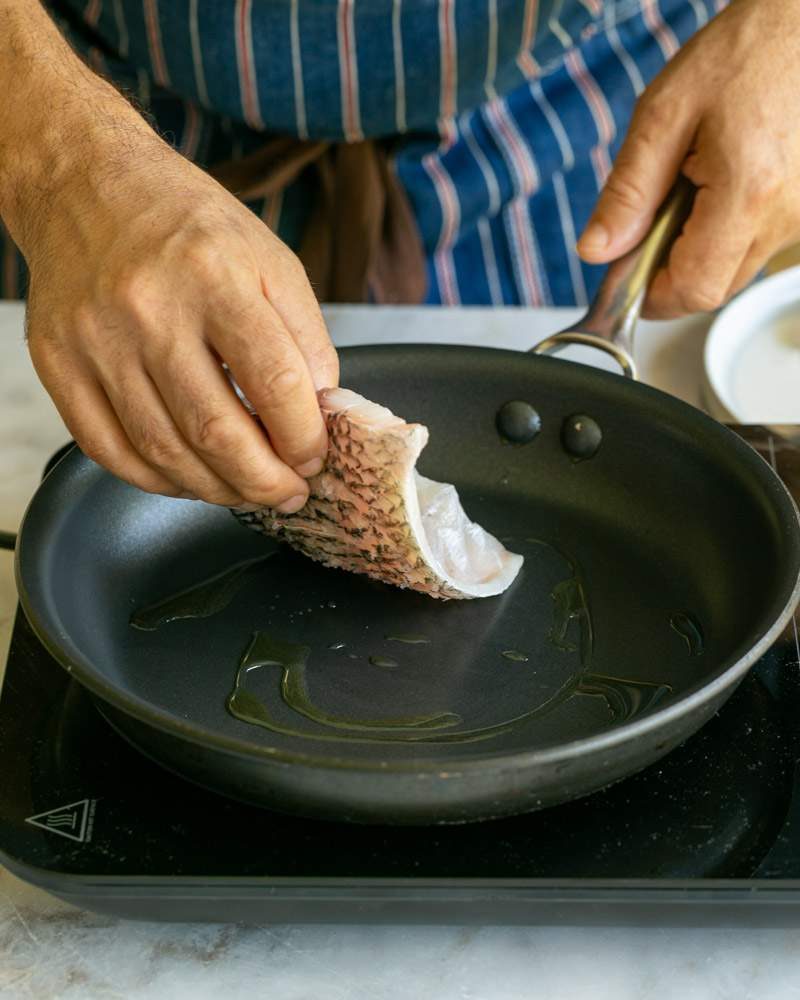 Pan frying Barramundi fish fillet