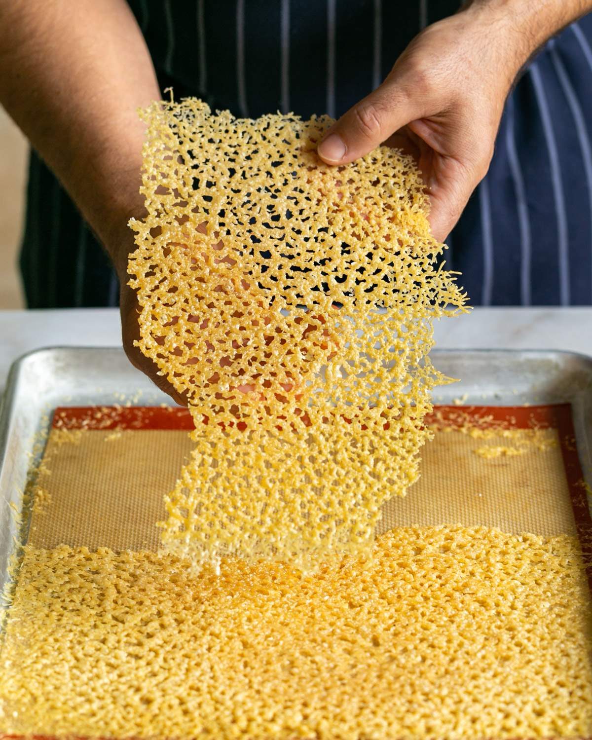 Showing texture of Parmesan cheese crisp in hands