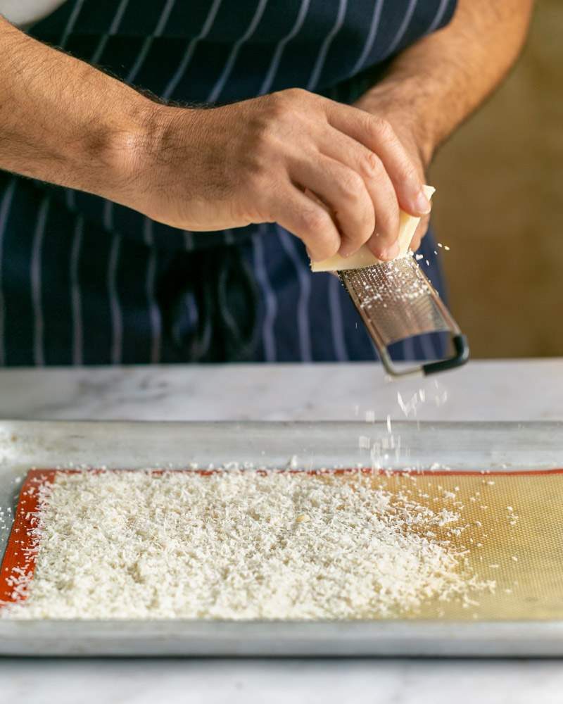 Grating parmesan in baking tray