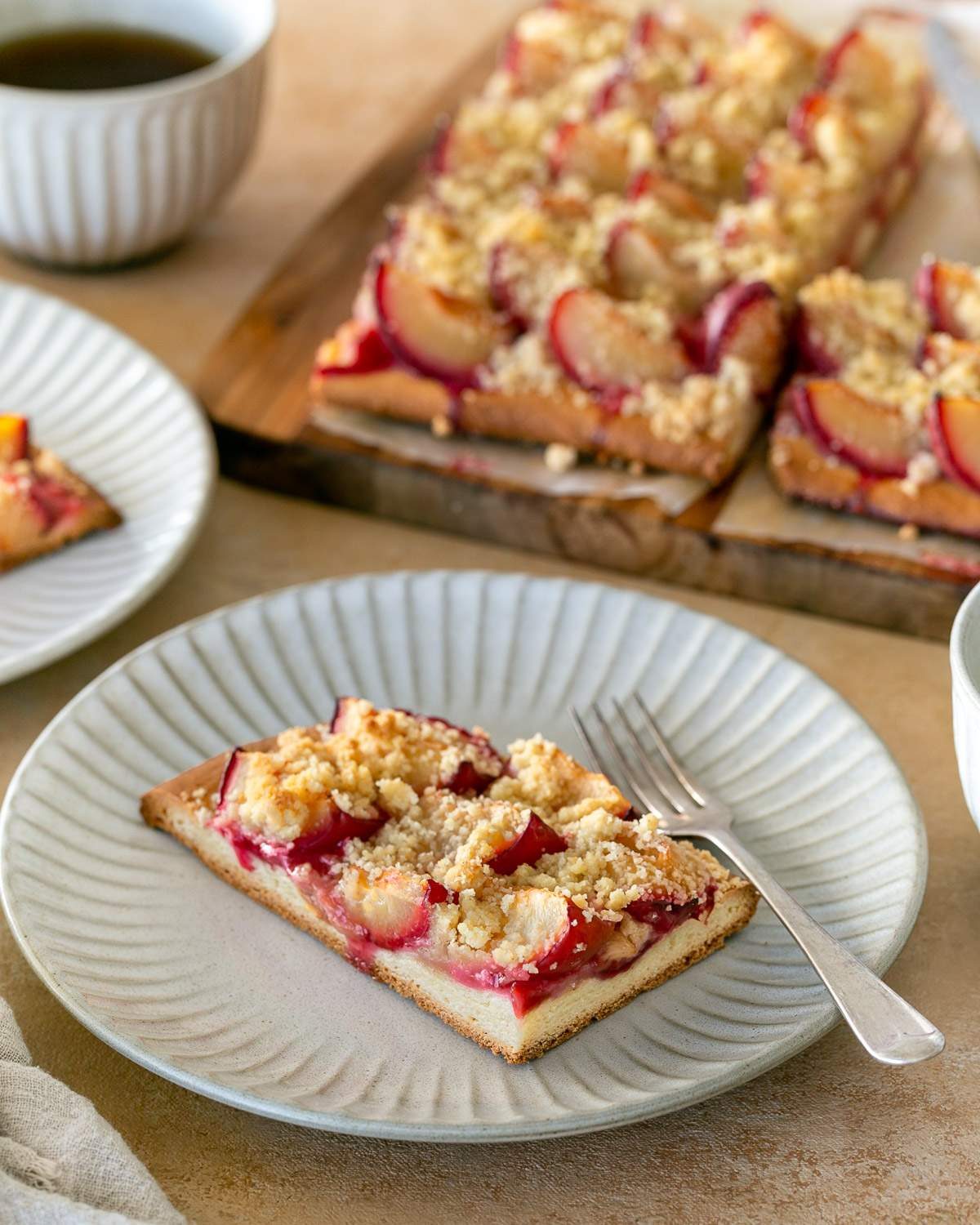 Slice of German plum tart on a plate