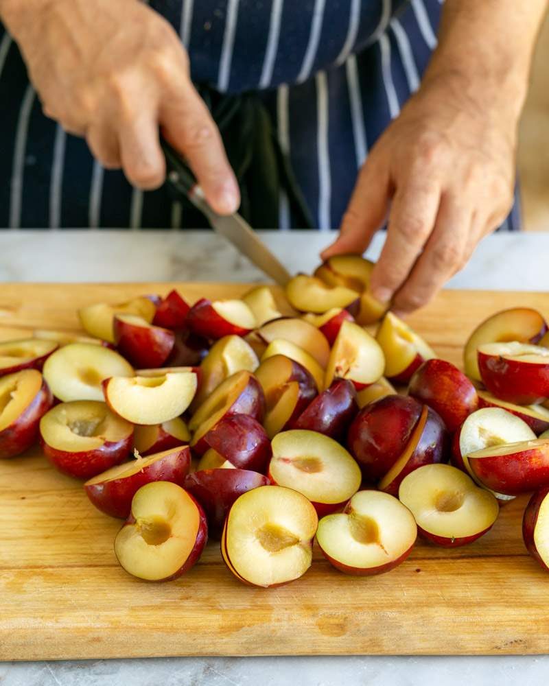 deseeding and cutting plums in half