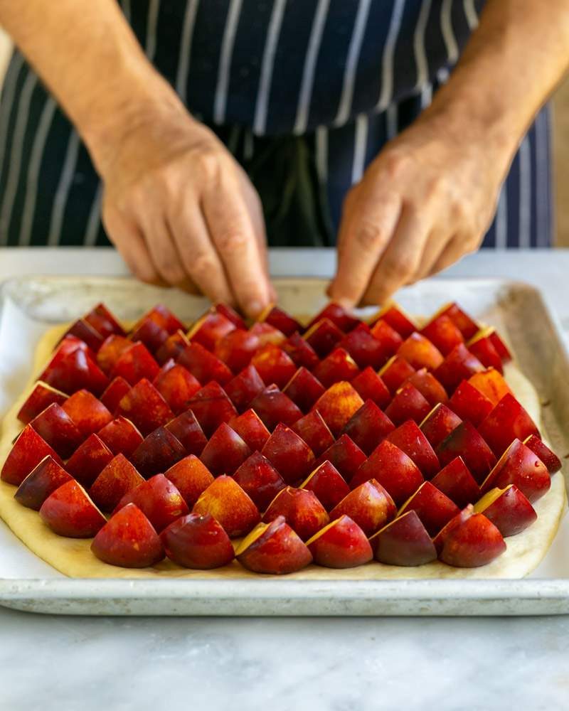 Layering the dough with cut plums