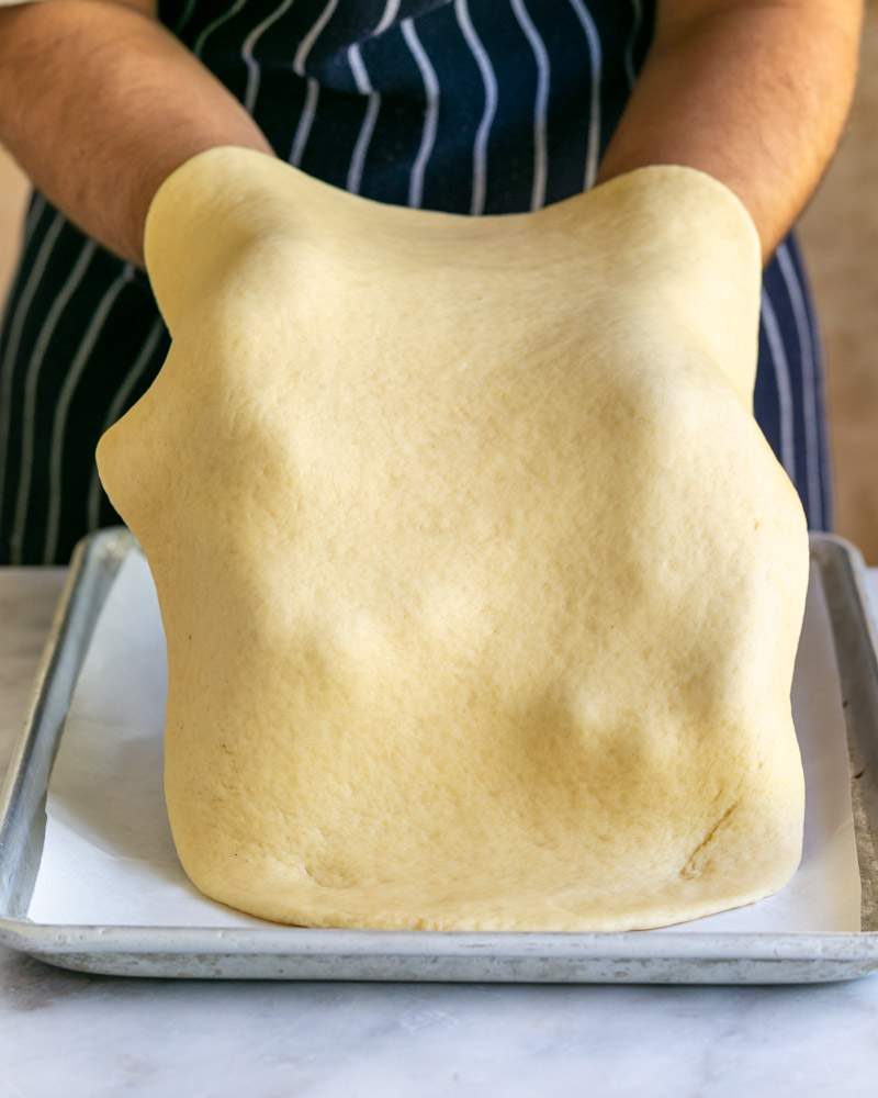 Rolled dough transferred to lined baking tray