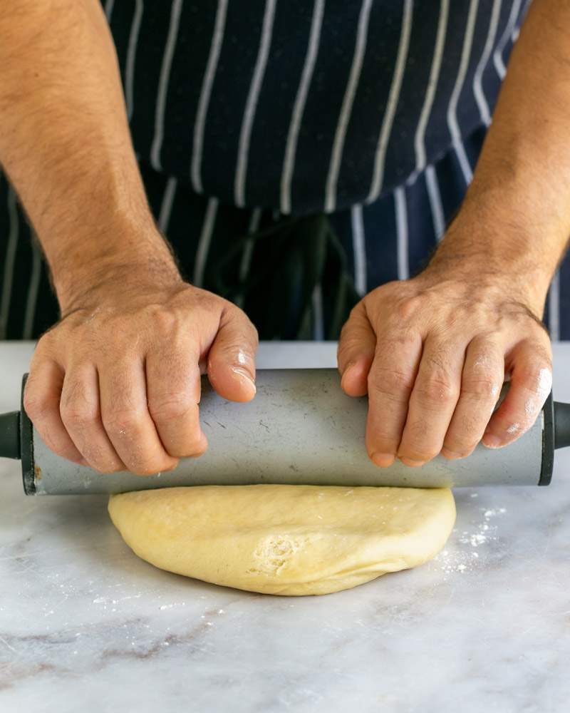 Rolling the dough for the plum cake