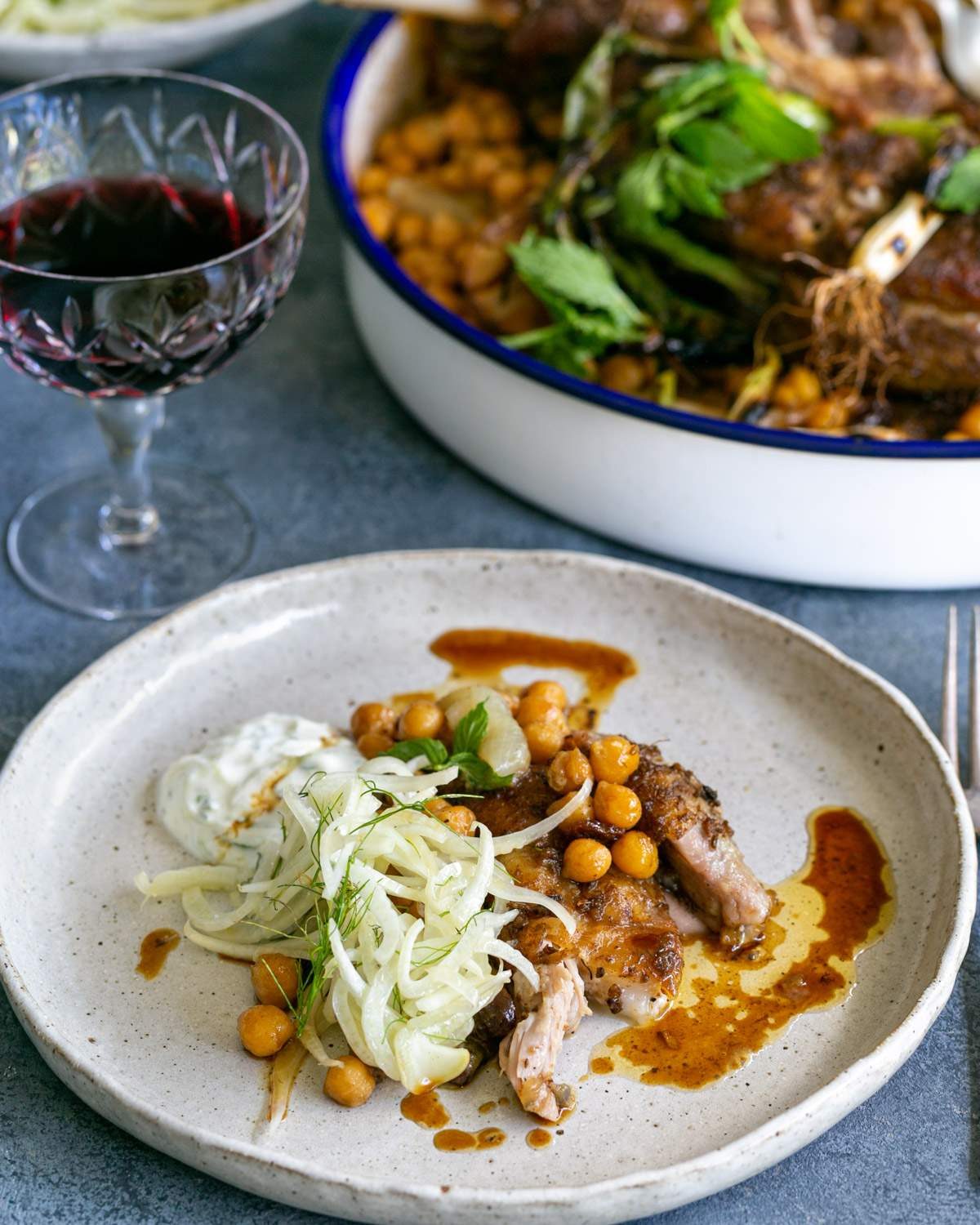 Lamb shoulder served in a plate with chickpeas and fennel salad