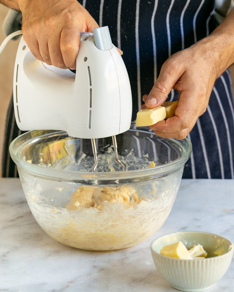 Adding butter to brioche dough